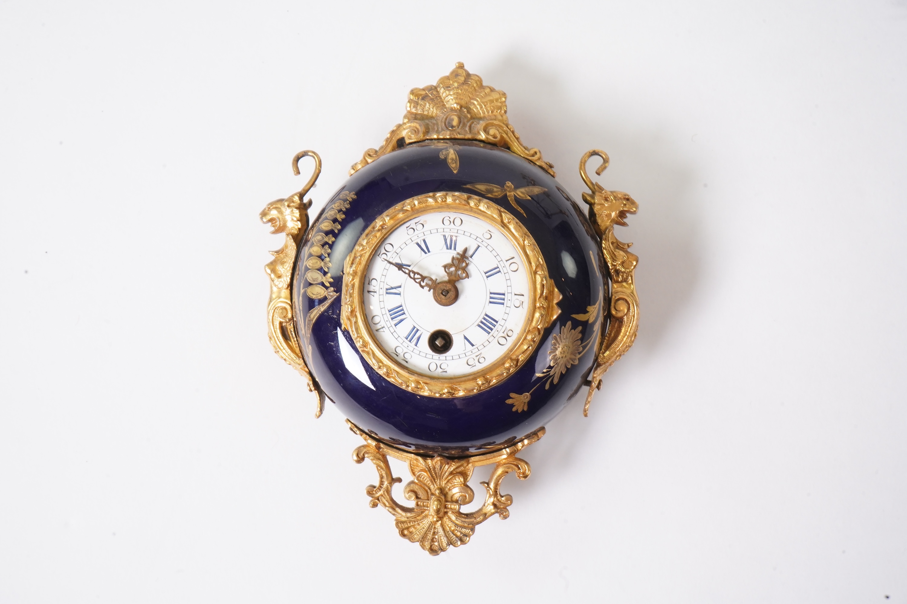 An unusual enamel and gilt brass timepiece, pendant from gilt brass frame, stand 26cm high. Condition - dismantled